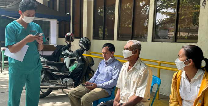 Image of Khorn, accompanied by his family, during the "pre-ops" interview being conducted by our amazing Watsi rep Sila at our medical partner center (CSC) in Phnom Penh, Cambodia.