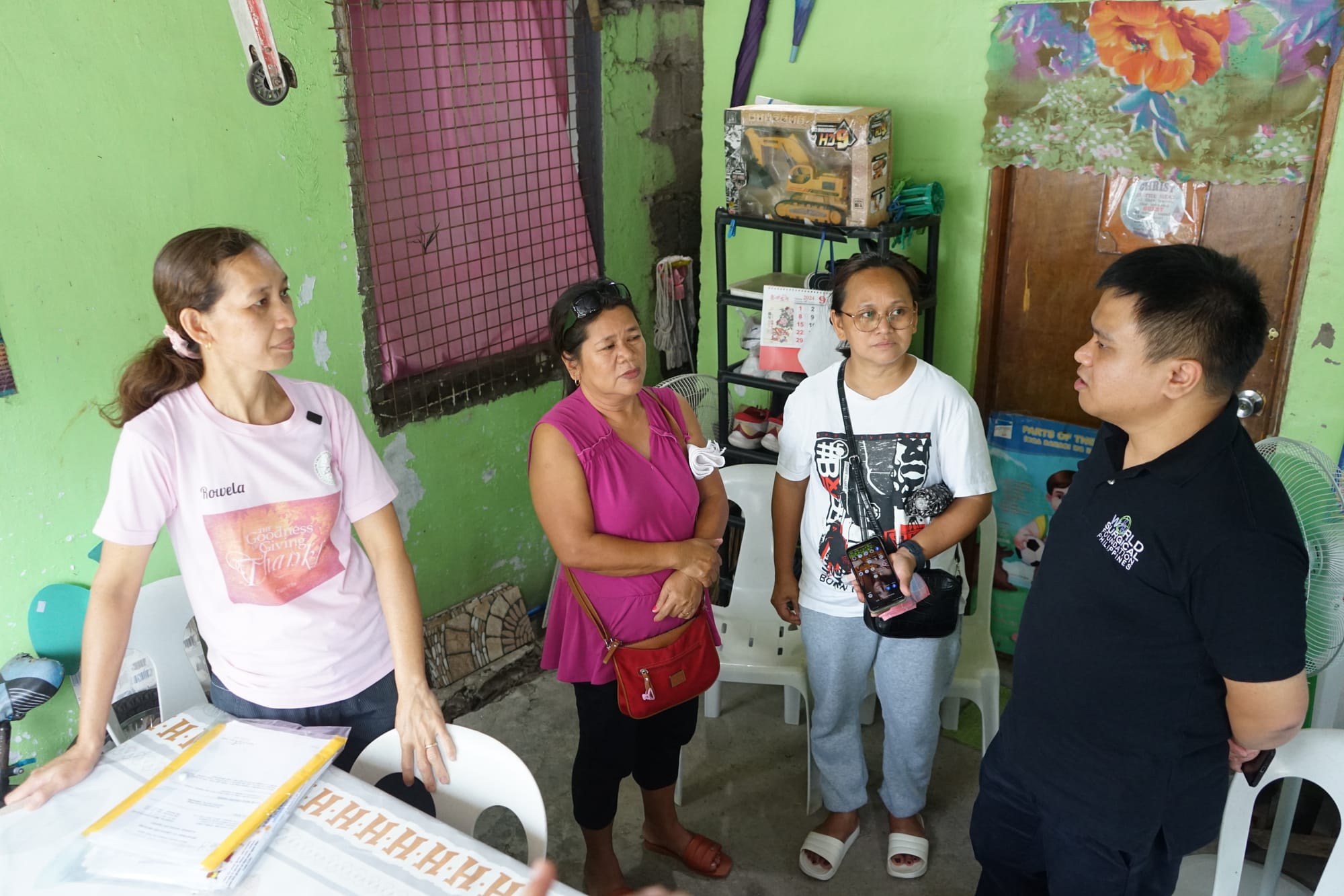 A photo of Watsi's medical partner WSFP meeting Rowela and her family post her breast cancer surgery